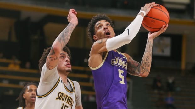 James Madison Dukes guard Terrence Edwards Jr. (5) is defended by Southern Miss Golden Eagles guard Donovan Ivory (15) during the first half at Reed Green Coliseum in Hattiesburg, Mississippi, on Jan. 6, 2024.